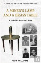A Miners Lamp And A Brass Table